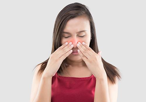 Woman suffering from severe nasal congestion