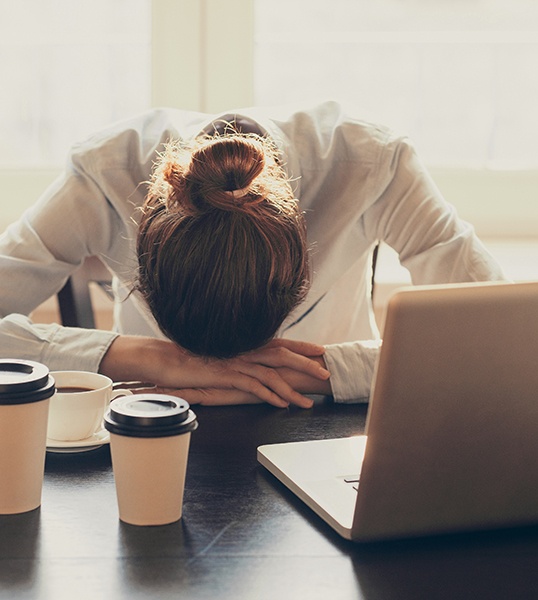 Woman asleep at a desk