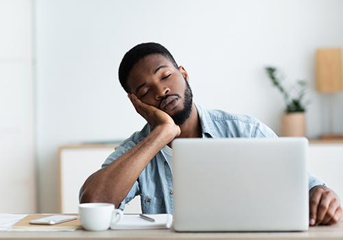 Man exhausted at his desk