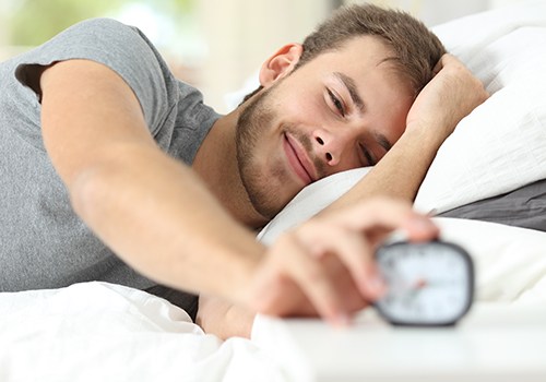 Man waking up after night of good sleep